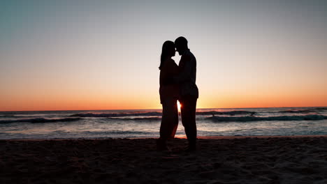 Sunset,-beach-and-couple-with-silhouette