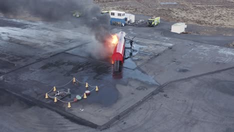 fire blazing on dummy aircraft at airport training grounds in iceland