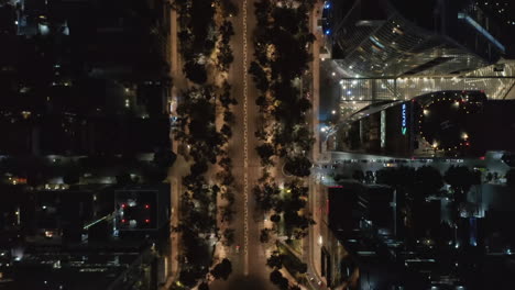 Aerial-birds-eye-overhead-top-down-panning-view-of-cars-driving-in-streets-of-downtown-illuminated-by-streetlights.-Drone-view-of-night-city.-Mexico-City,-Mexico.