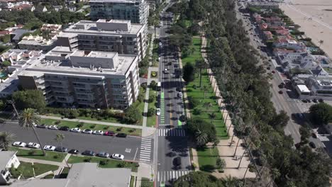 Aerial-view-of-famous-Ocean-Ave-lined-with-palm-trees,-next-to-Pacific-Coast-Highway-in-Santa-Monica-California