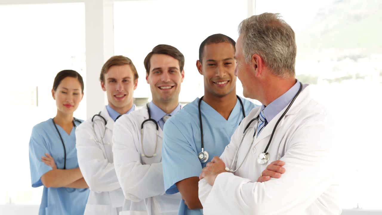 Medical team crossing arms and looking at camera