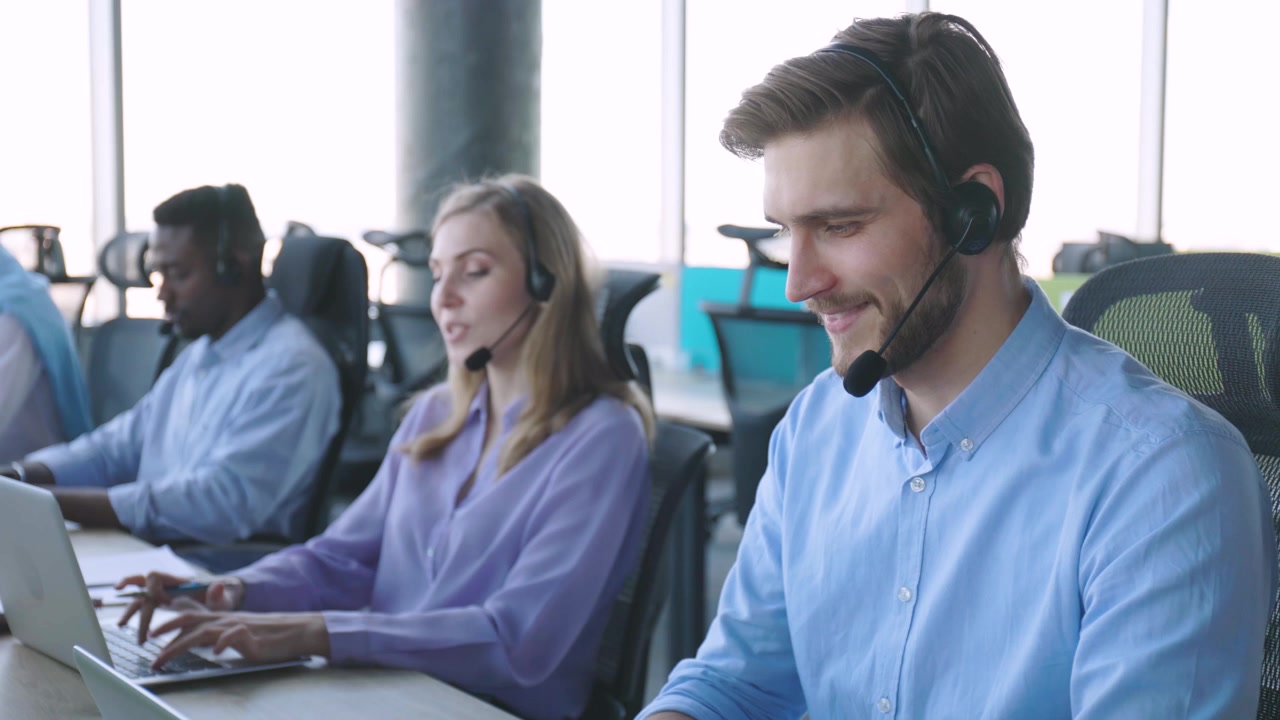 Customer Service Agents Working with Headsets in a Modern Office