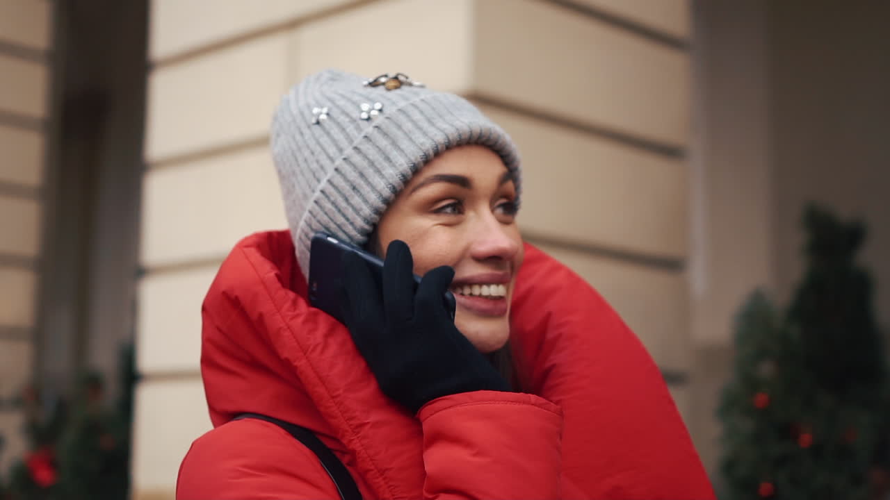 Woman in winter clothing talking on phone