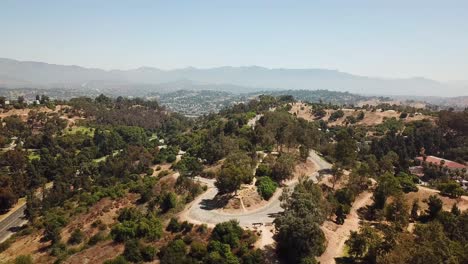 Driving-car-on-serpentine-road-in-Elysian-Park-during-sunny-day