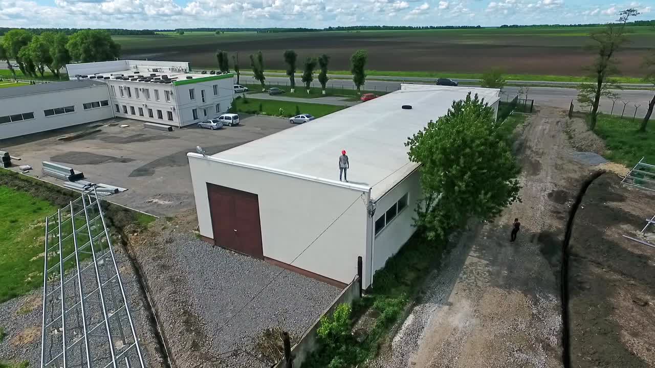 Construction site worker. Aerial shot of busy construction site