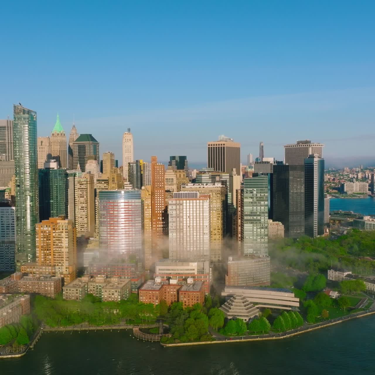 Manhattan island beautiful architecture. Fog coming to the city from blue waters of the river. Aerial perspective