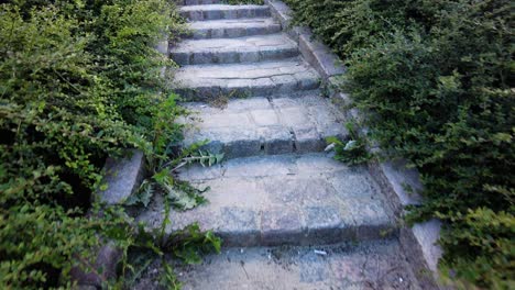 climbing up on narrow pebblestone stairway at daytime