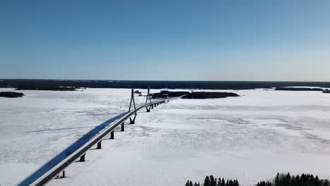 aerial ascend over replot bridge during winter sunny day, finland