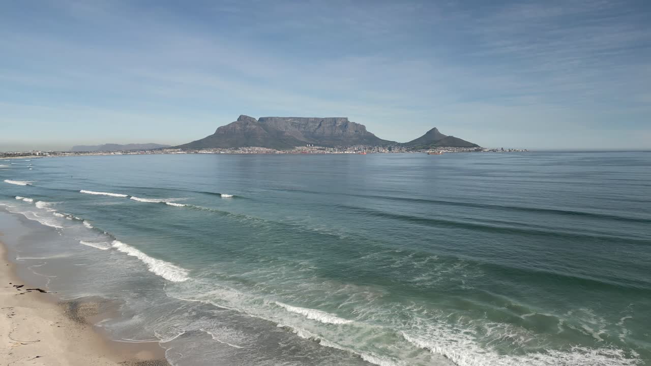 Drone shot pulling away from Table Mountain off Africa's coast