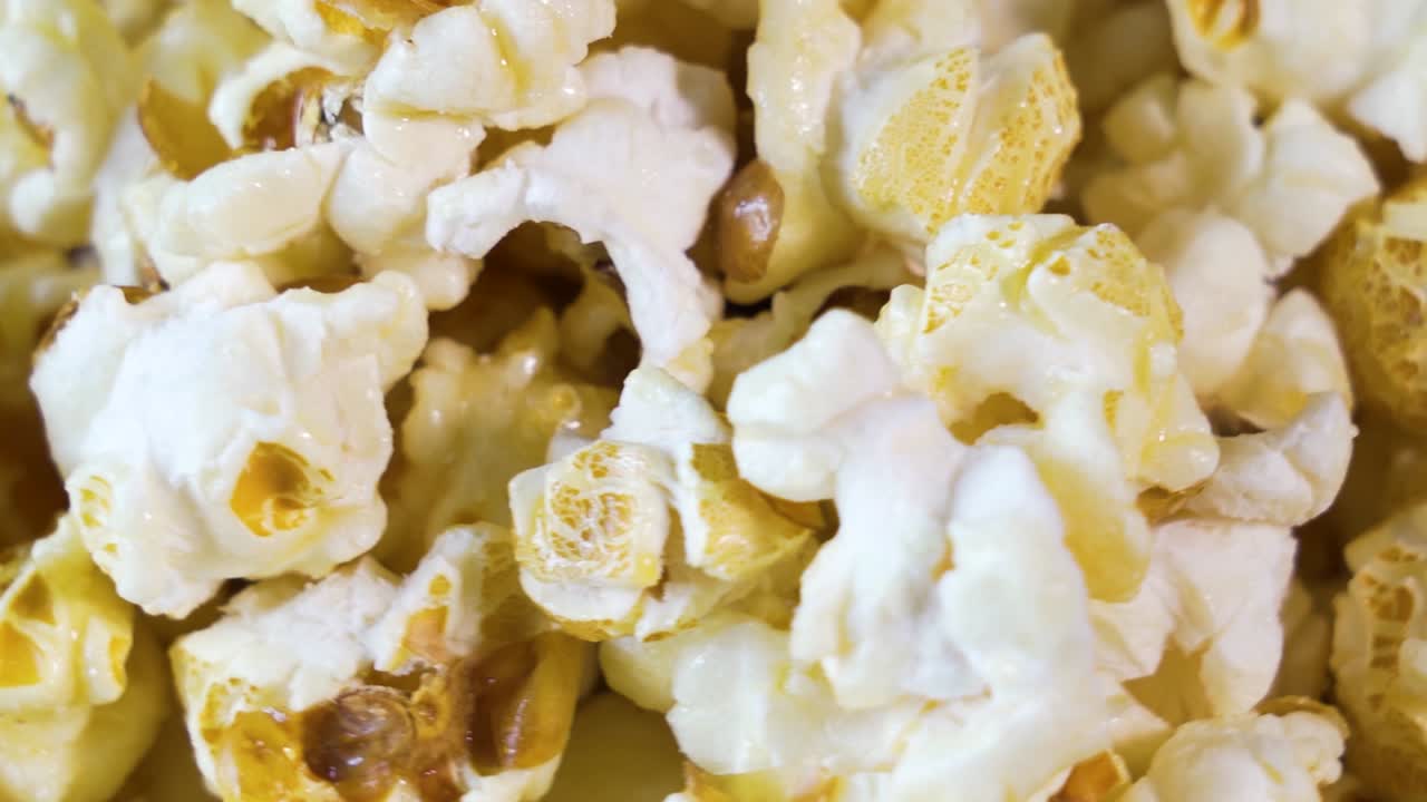 Popcorn in yellow butter, delicious close-up beauty shot