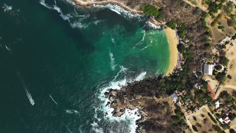 aerial view above the rocky coast of puerto escondido, mexico - cenital, drone shot