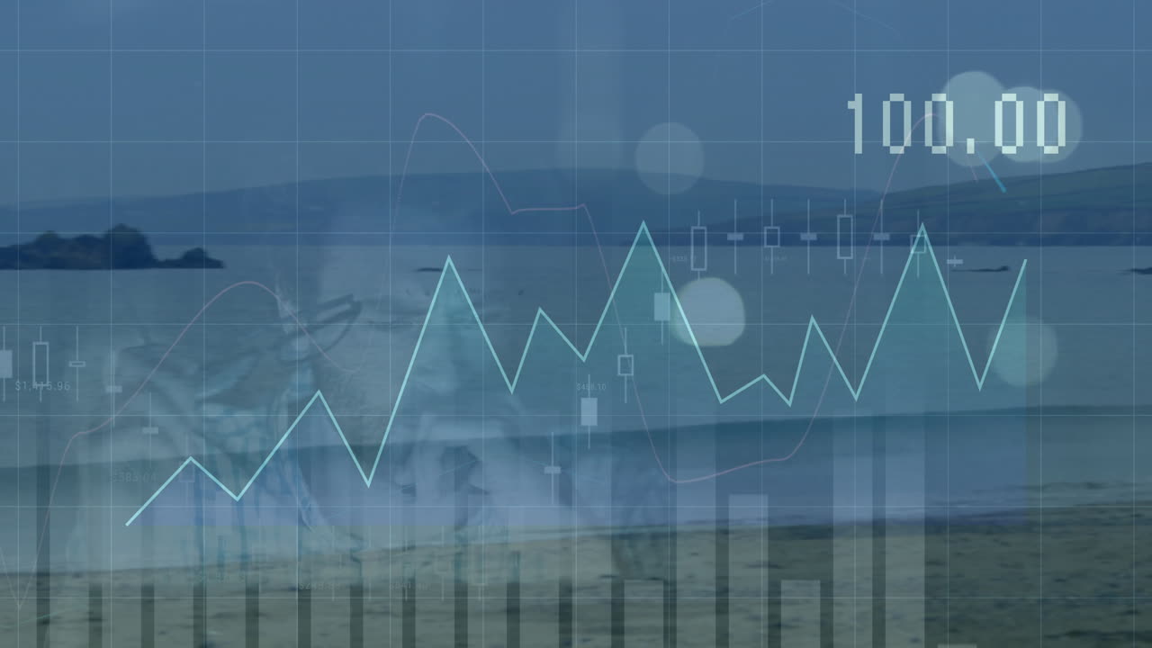 Designer overlaying finance charts on coastal beach, showcasing turquoise line graph and 100