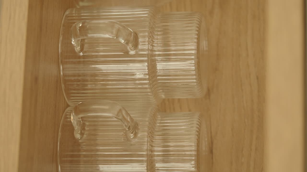 Clear Glass Mugs on Wooden Shelf