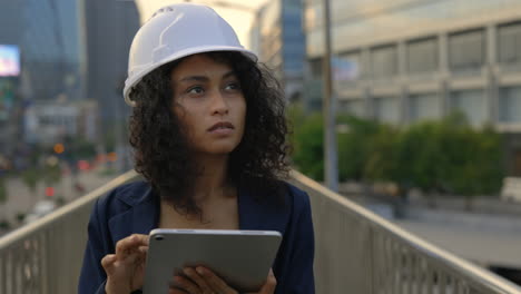 woman engineer with tablet on city bridge