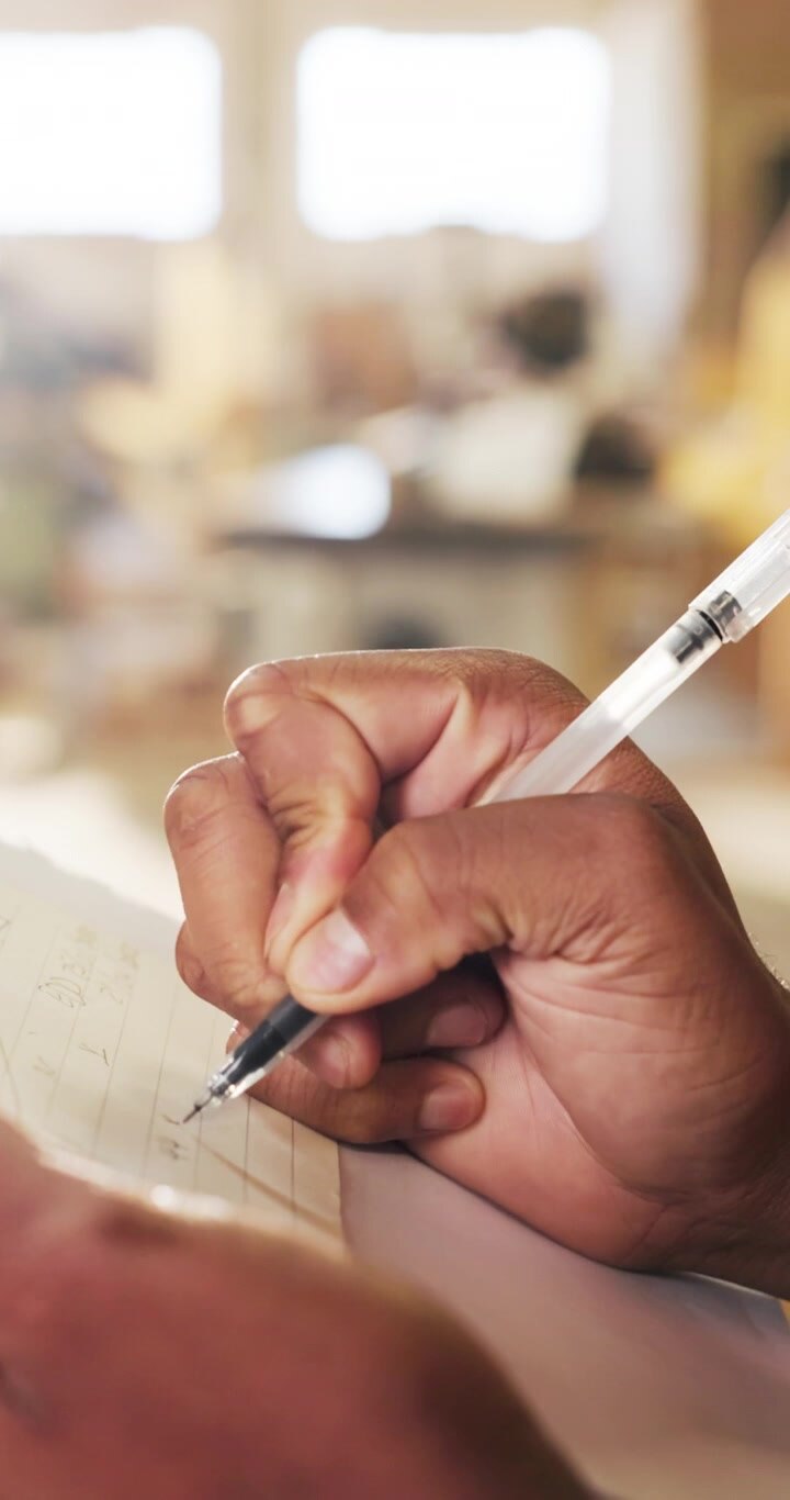 Close-up of a Person Writing Notes on Paper