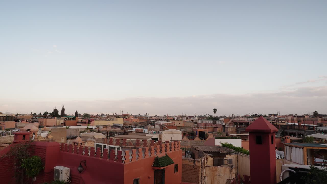 Wide rooftop view of Marrakech Medina showing traditional houses and city skyline
