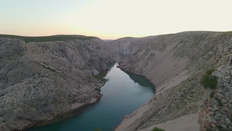 drone flying over green river zrmanja canyon in croatia at golden hour