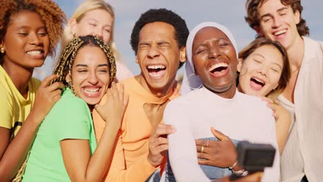 happy multi-ethnic friends laughing while filming with wearable camera outdoors