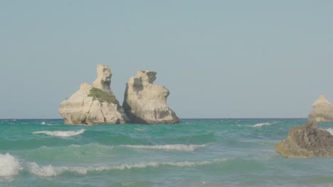 Plano-Amplio-En-Cámara-Lenta-De-Las-Dos-Hermanas-Con-Cielo-Azul-Claro-Y-Agua-Turquesa