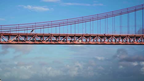 slow motion: train moving on 25th of april bridge in lisbon, portugal