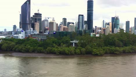 aerial view drone flyover brisbane river, elevation shot capturing riverside queensland university of technology research institution qut gardens point campus at downtown brisbane city