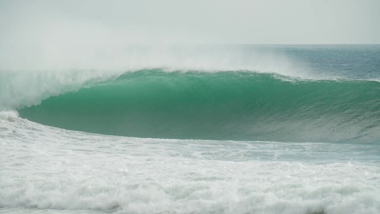 Emerald Elegance: The Perfect Wave Unleashing a Green Tube