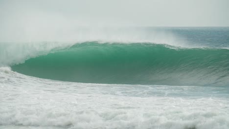 emerald elegance: the perfect wave unleashing a green tube