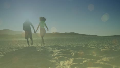 Animation-of-light-spots-over-african-american-couple-walking-and-holding-hands