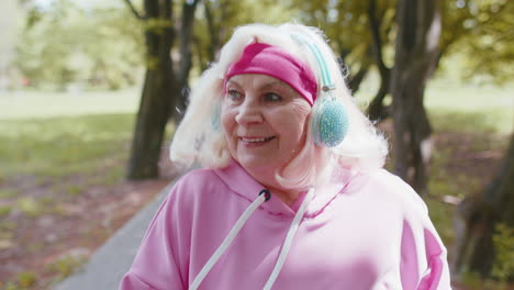 senior athletic woman grandmother running jogging in park during morning workout cardio outdoors