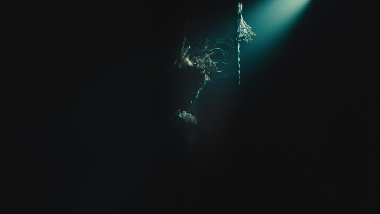 The witch makes a beckoning gesture with her hand