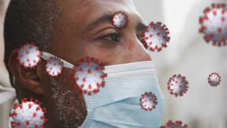 animation of covid 19 cells over african american man wearing face mask