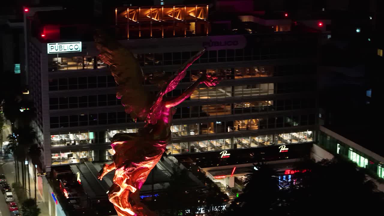 Aerial view taken by drone of the "Victoria Alada" sculpture, commonly known as the 'Angel de la Independencia', crowning the Independence Column over Paseo de la Reforma in the heart of Mexico City
