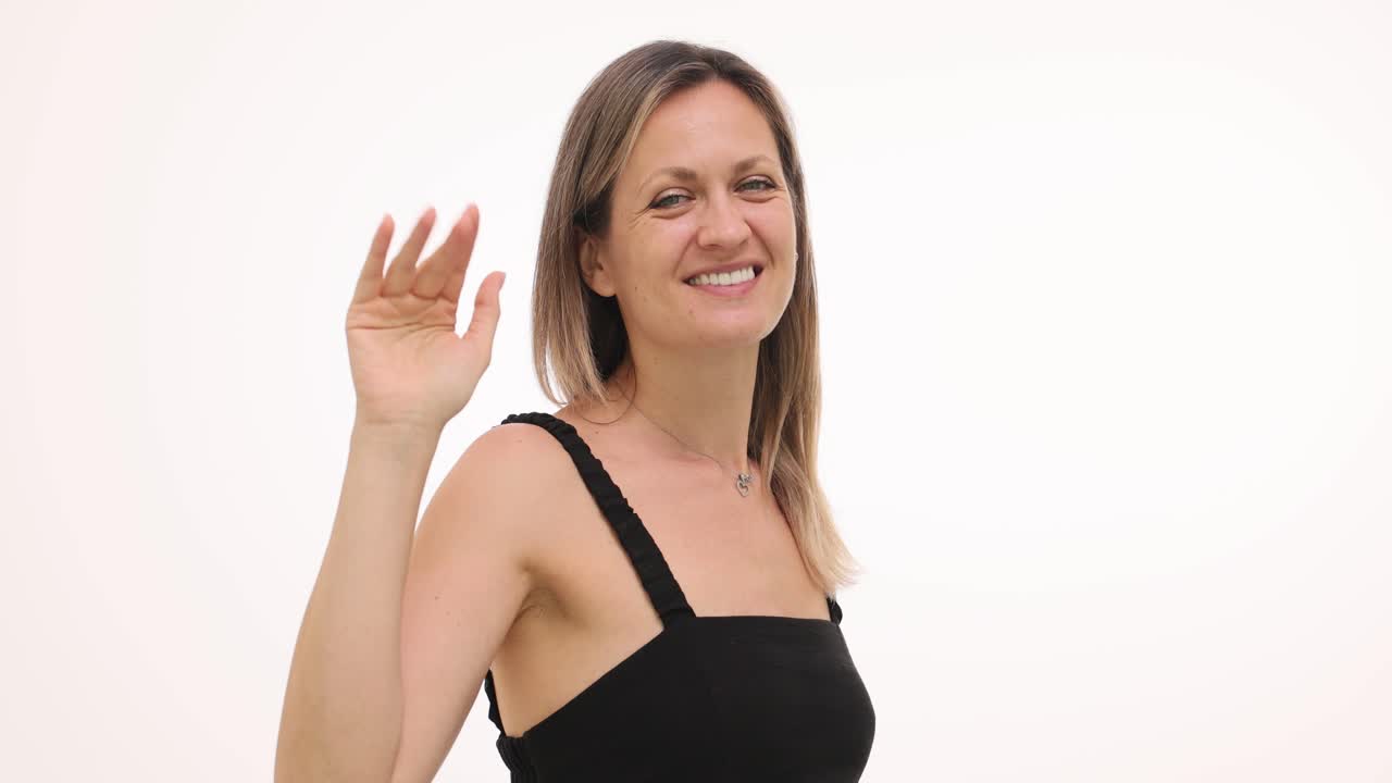 A smiling woman waving