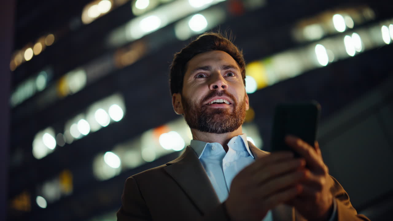 Elegant man typing phone sms at evening lights city closeup. Manager messaging