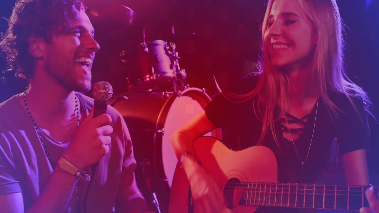 Male singer holding microphone and female guitarist strumming with animated sound waves for music