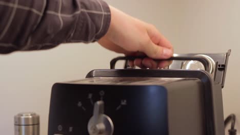 Inserting-new-filled-water-tank-inside-coffee-machine,-static-closeup