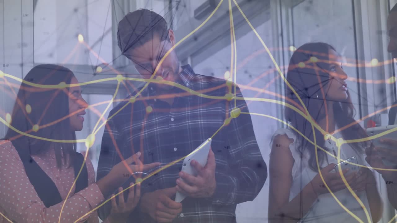 Woman pointing tablet activating animated waves, colleagues joining smartphones for data analysis