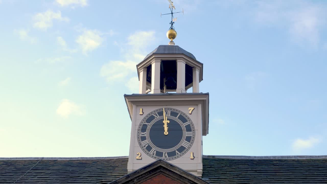 Large clocktower with roman numerals and weather