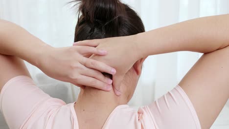 Close-up-of-tired-woman-massaging-rubbing-stiff-sore-neck-tensed-muscles-fatigued-from-work-in-incorrect-posture-feeling-hurt-joint-shoulder-back-pain-ache-close-up-rearview