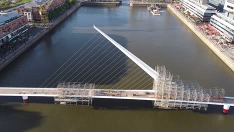 aerial flight over woman's bridge during constriction site at puerto madero area in buenos aires city