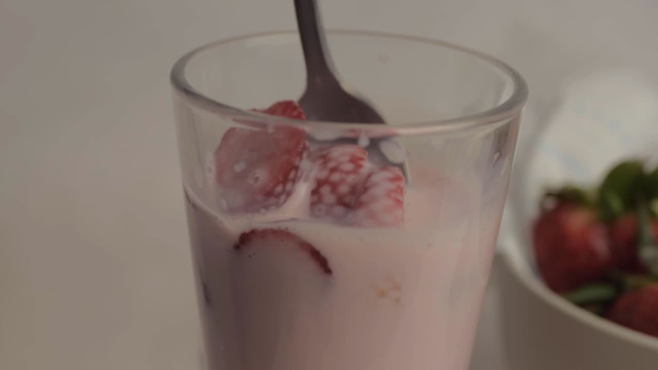 Primo piano di fragole mescolate e gustate da un frullato con frutta fresca