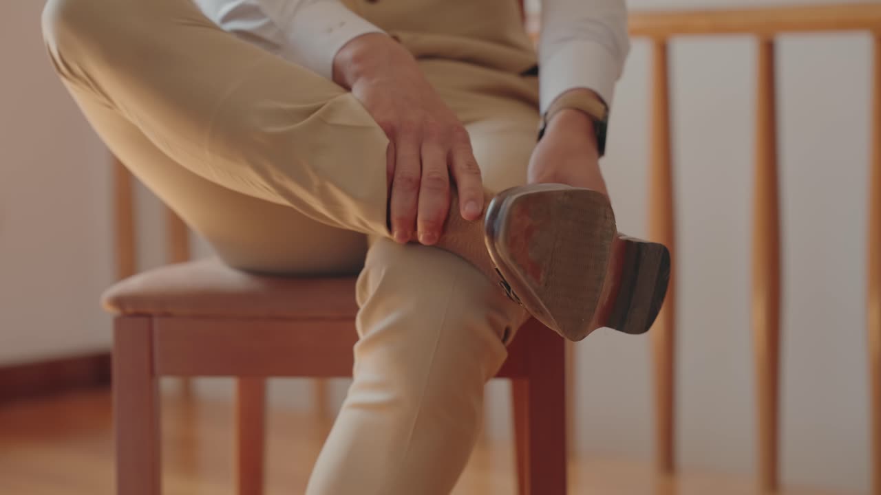 Intimate closeup of hands refining formal attire in a moment of wedding anticipation