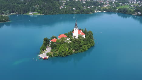 aerial view: boat cruise and island with church at lake bled, slovenia