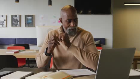 portrait of happy african american businessman looking at camera at office
