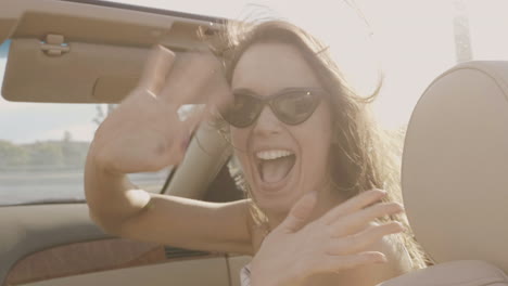 woman enjoying a convertible car ride on a sunny day