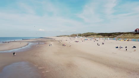 a lot of people relaxing at a beach in the netherlands