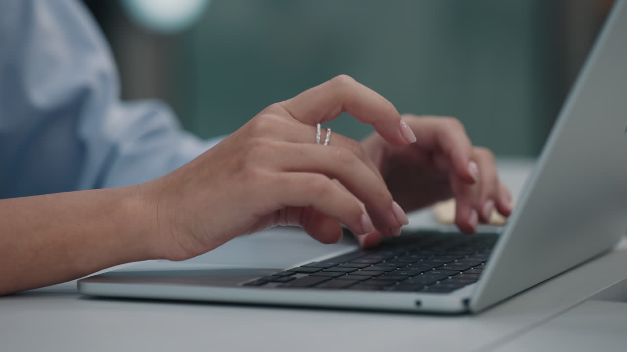 Woman typing on a laptop