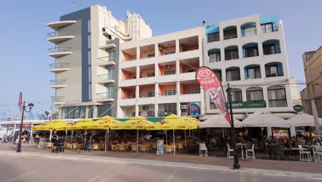 lively promenade with outdoor cafes and hotels in malta