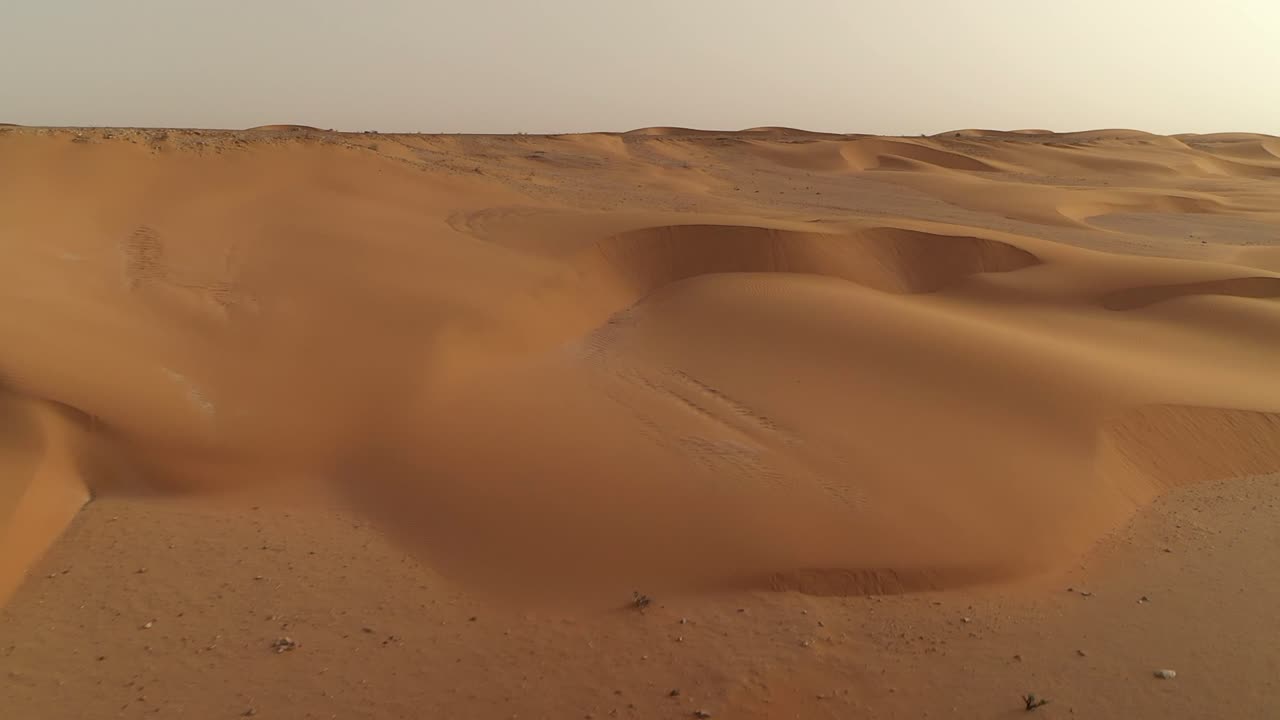 Vast, undulating sand dunes in El Agunia, Morocco, concept of freedom, adventure, desolate beauty. Aerial drone low flight, copy space