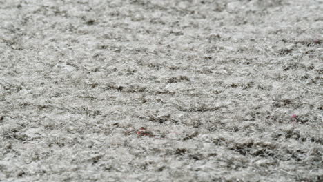 close-up view of a gray carpet or fabric surface